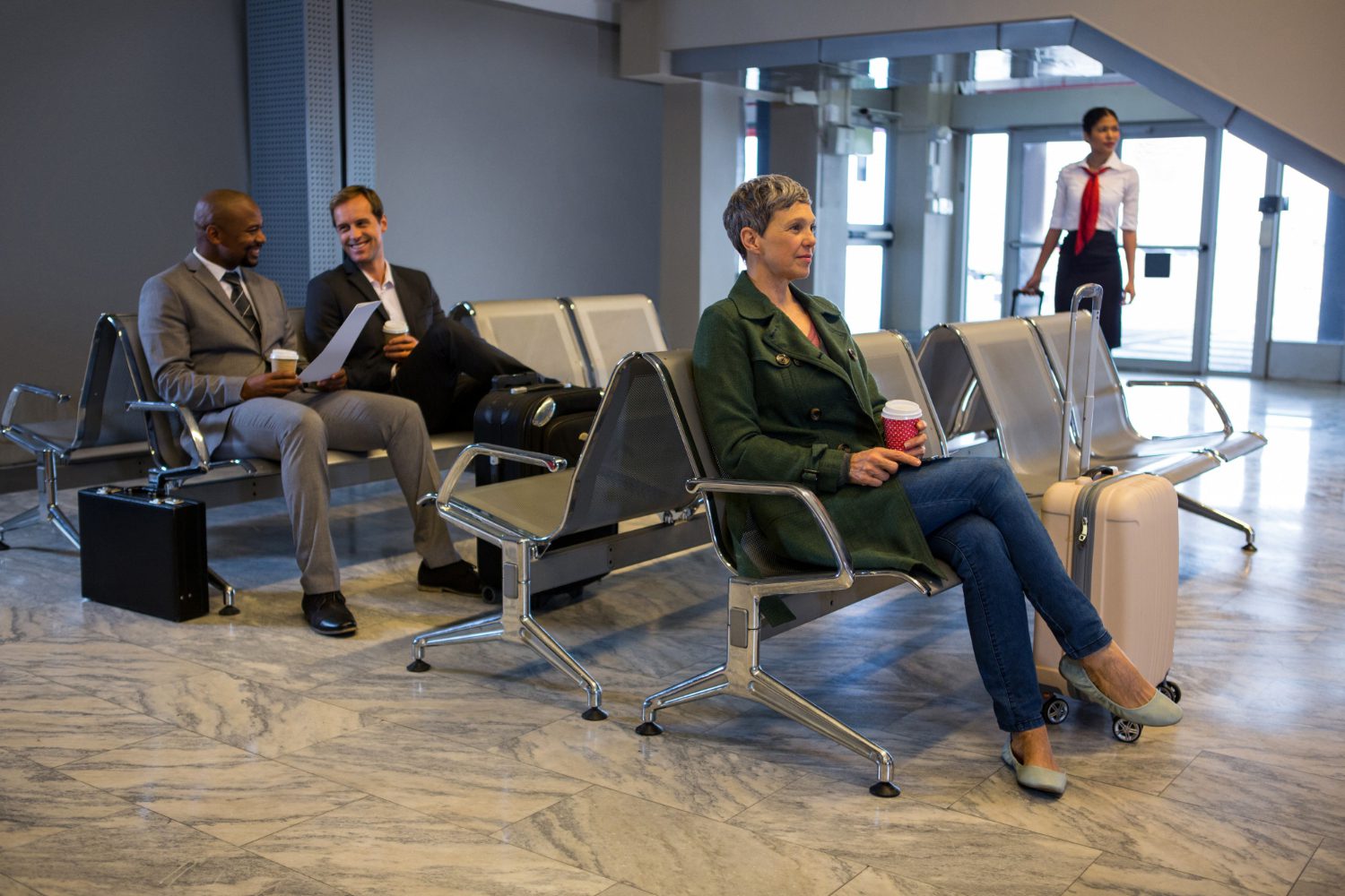 Passengers waiting in airport terminal seating area