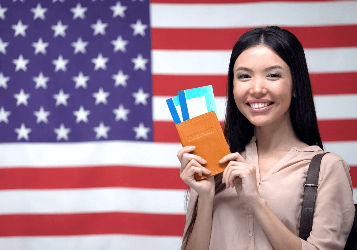 Woman holding passport, US flag background