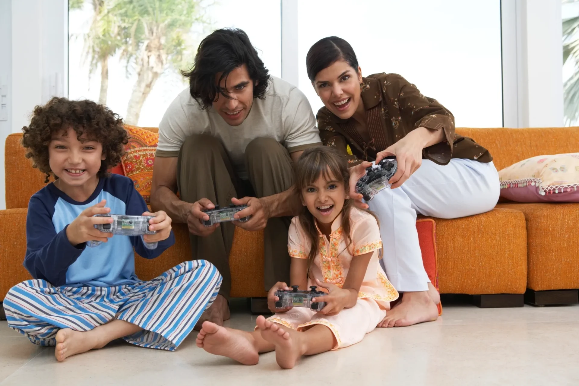 Family playing video games together on floor
